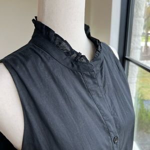 Sleeveless dress with ruffle neckline